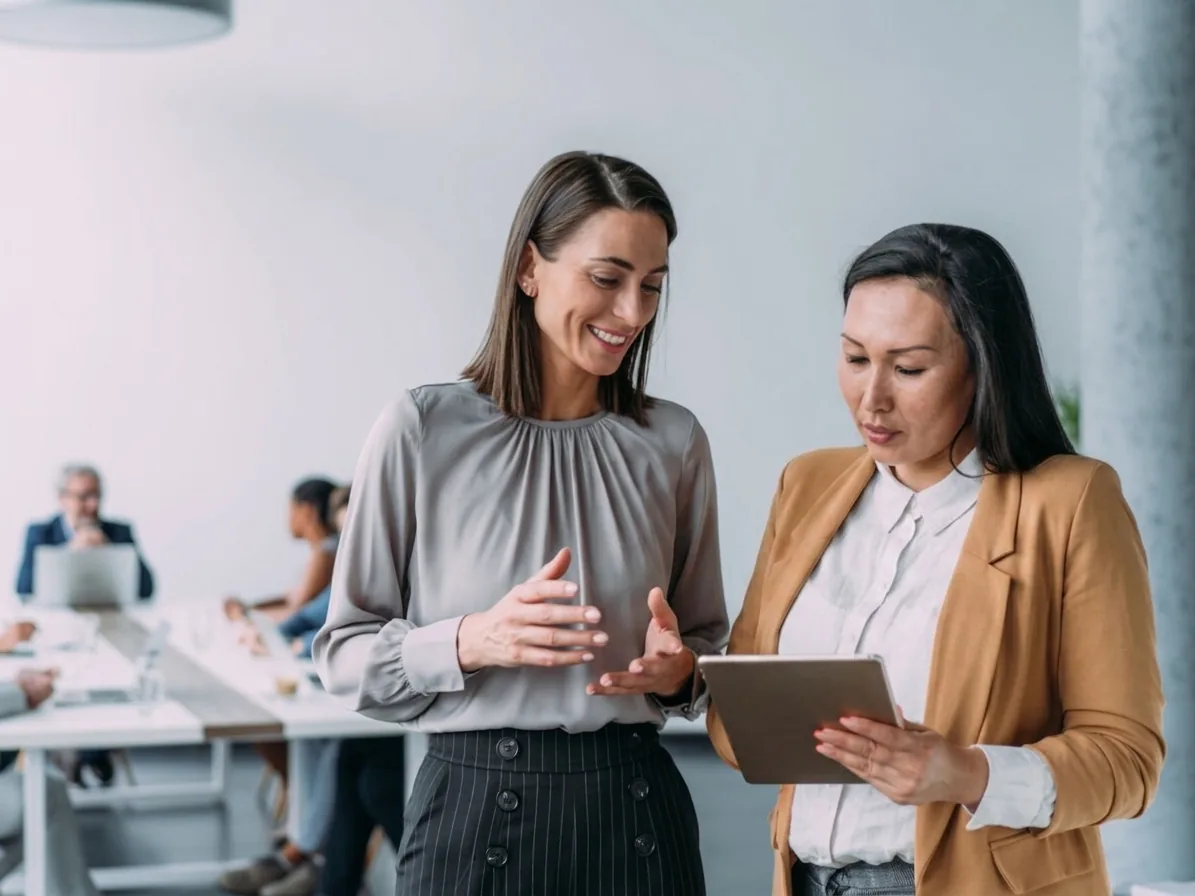 Two business owners reviewing a plan together on a tablet